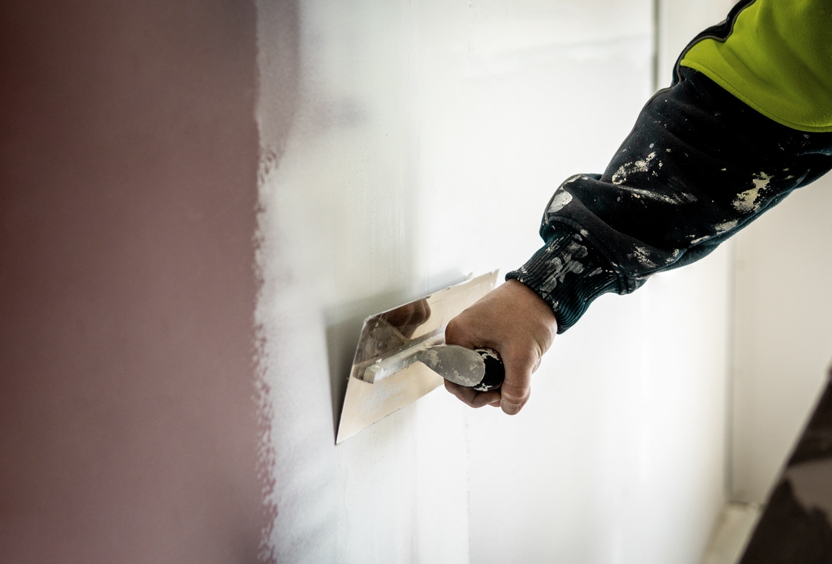 Plasterer repairing cracks to GIB board - Internal plastering services