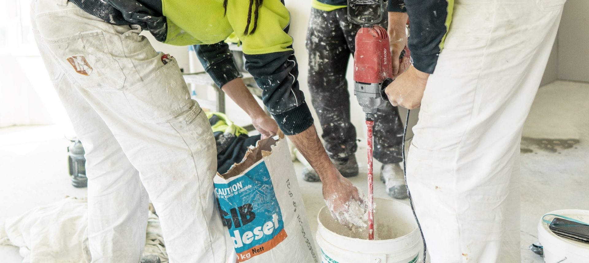 Three men plastering an internal residential home